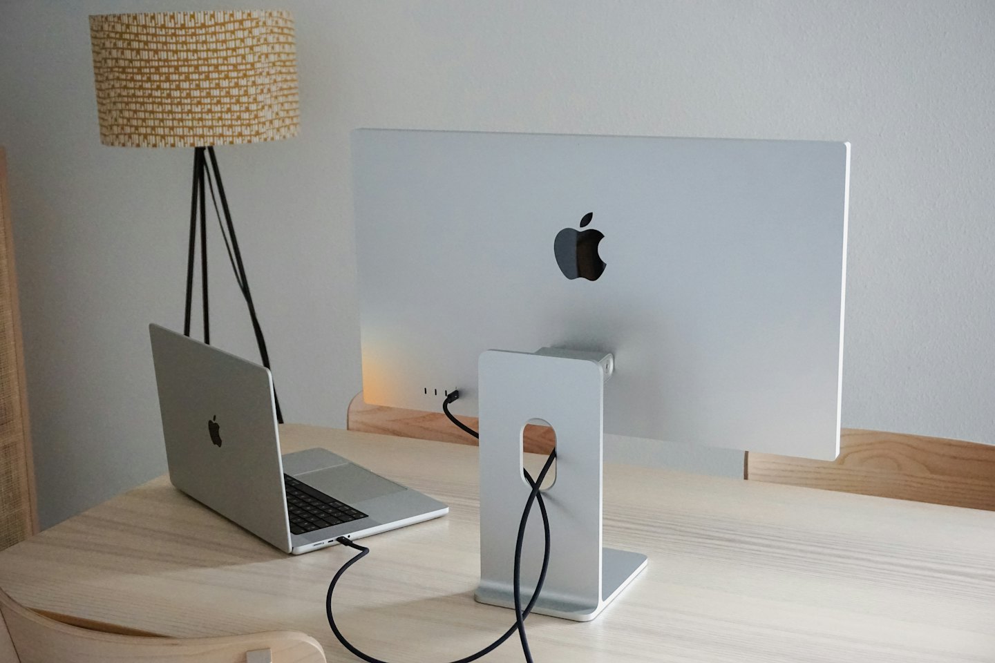 A laptop and external monitor on a wooden desk.